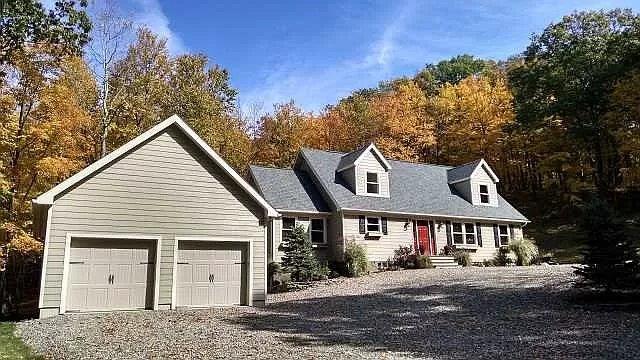 cape cod house featuring a garage