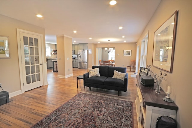 living room featuring a notable chandelier and light hardwood / wood-style floors