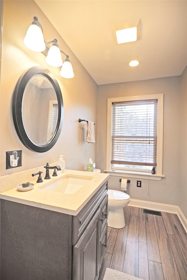 bathroom featuring hardwood / wood-style floors, vanity, and toilet