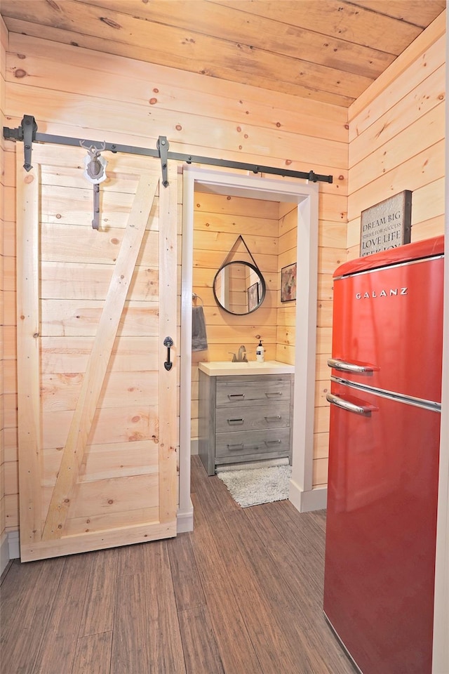 interior space featuring hardwood / wood-style flooring, wood walls, and wood ceiling