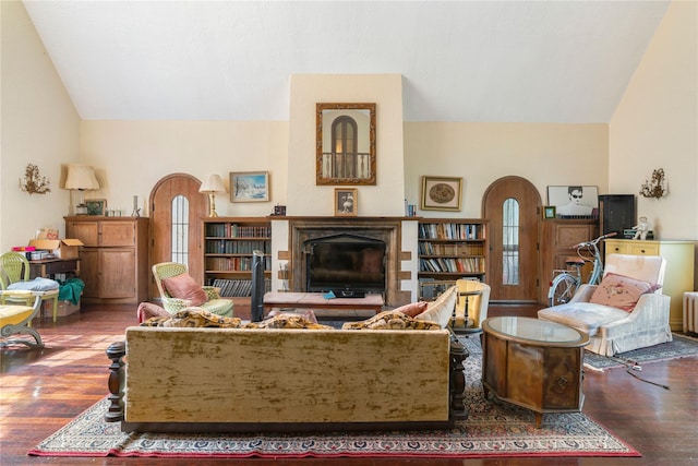 living room featuring hardwood / wood-style floors, lofted ceiling, and radiator heating unit