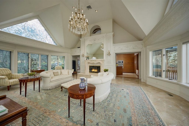 living room featuring a high end fireplace, a towering ceiling, and a chandelier