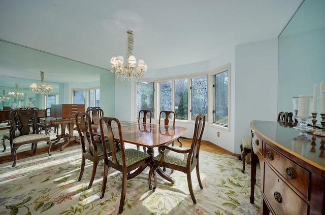 dining room with a chandelier, light wood-type flooring, and plenty of natural light