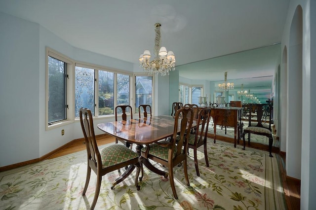 dining space with an inviting chandelier