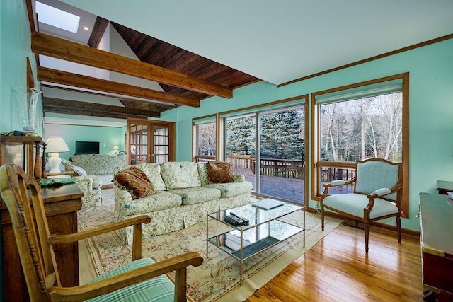 living room with beamed ceiling, wood ceiling, and light hardwood / wood-style flooring