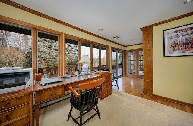 home office with light hardwood / wood-style flooring, french doors, and ornamental molding