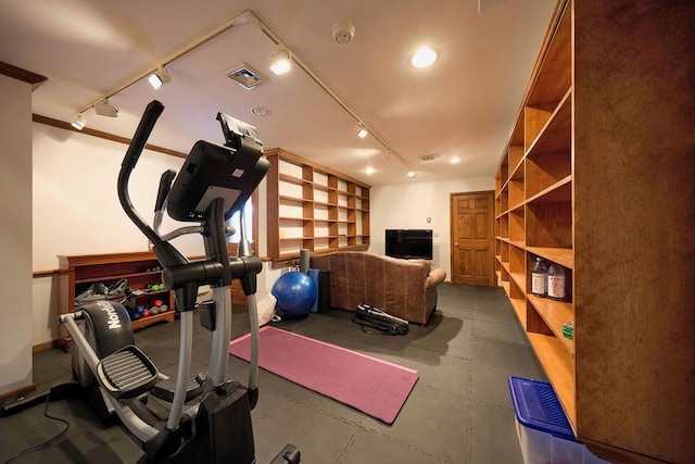 workout room featuring track lighting