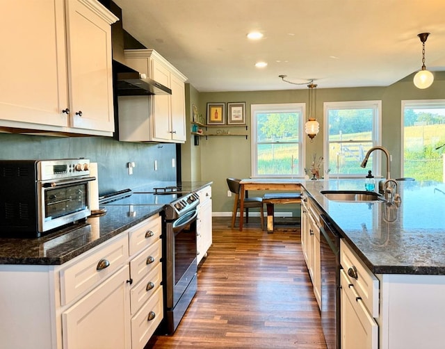 kitchen with pendant lighting, white cabinetry, stainless steel electric range oven, and sink