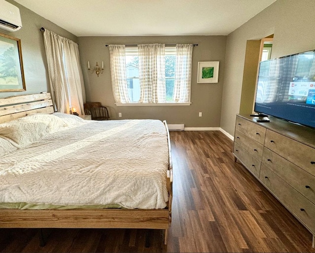 bedroom featuring dark hardwood / wood-style flooring and a wall unit AC