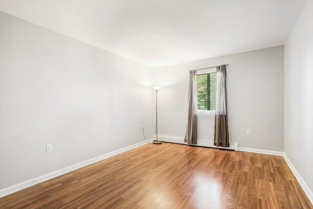 unfurnished room featuring hardwood / wood-style flooring