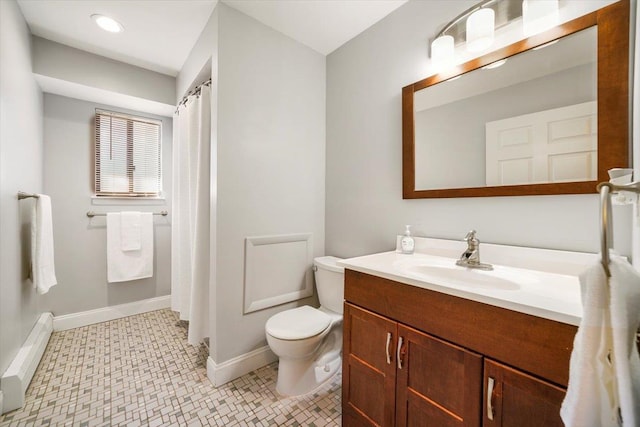 bathroom with vanity, toilet, and a baseboard heating unit