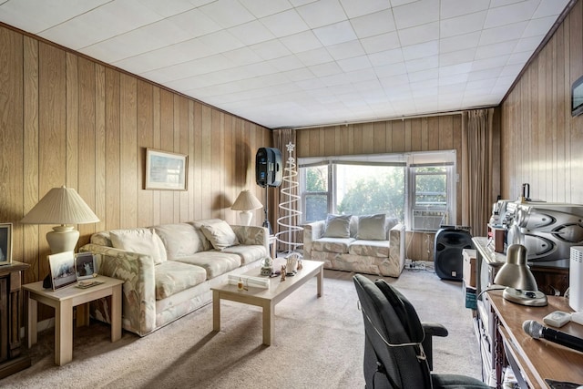 living room featuring wooden walls and light carpet