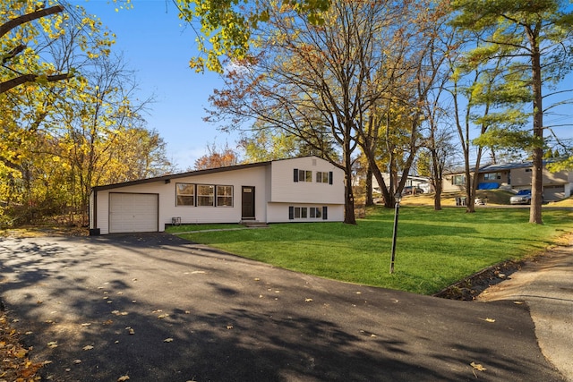 view of front of property with a front yard and a garage