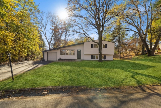 view of front of house with a front yard and a garage