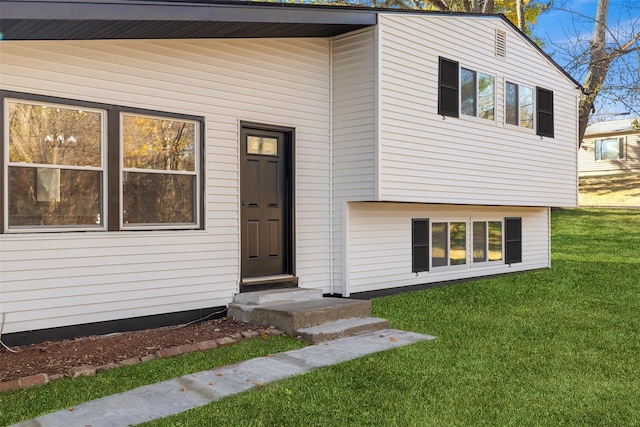 entrance to property with a lawn