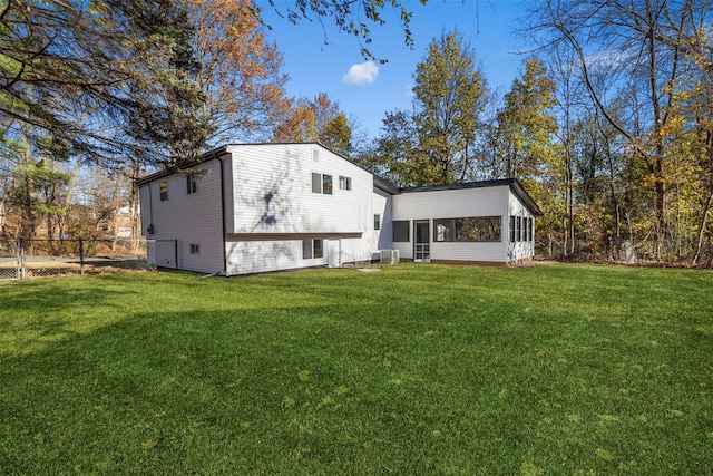 back of house featuring a yard, central AC, and a sunroom