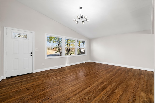 interior space featuring lofted ceiling, dark hardwood / wood-style floors, and an inviting chandelier