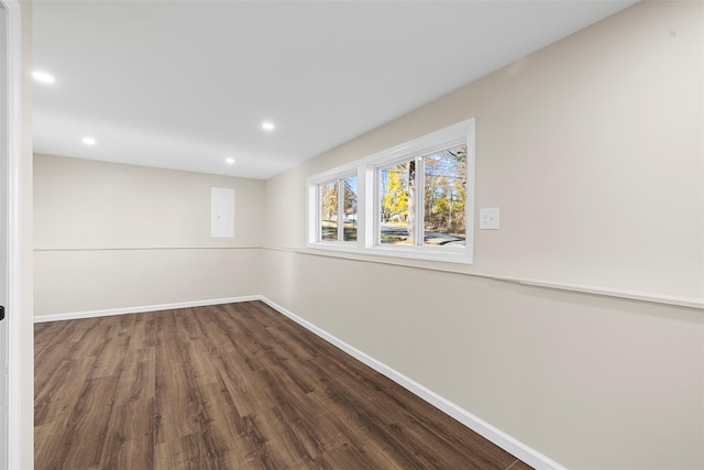 basement with dark hardwood / wood-style floors