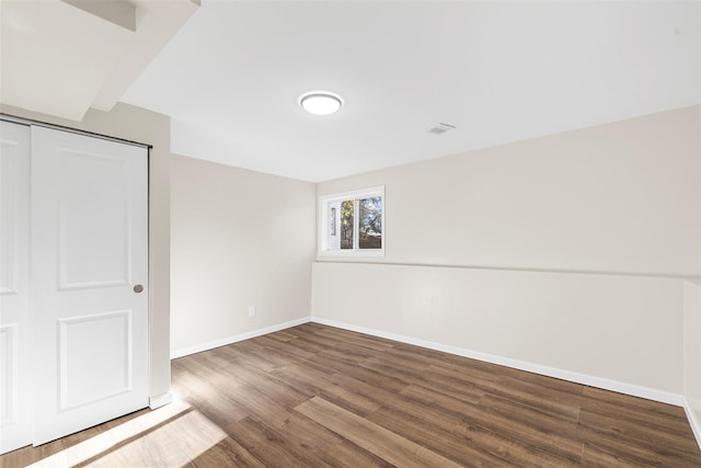 unfurnished bedroom with a closet and hardwood / wood-style flooring