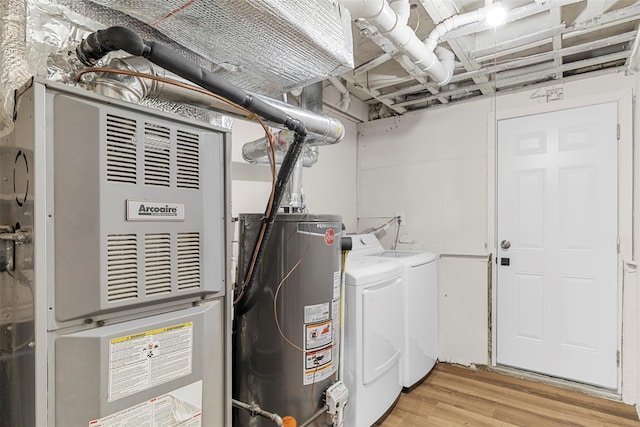 utilities featuring heating unit, separate washer and dryer, and water heater