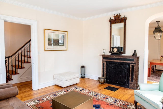 living room featuring wood-type flooring and crown molding