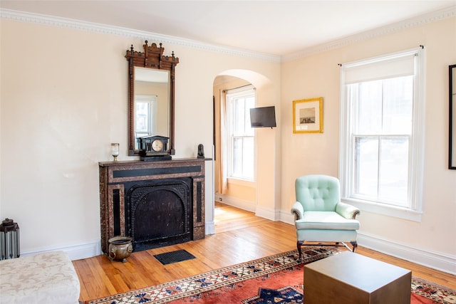 sitting room featuring crown molding and hardwood / wood-style flooring