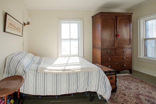 bedroom with multiple windows and crown molding