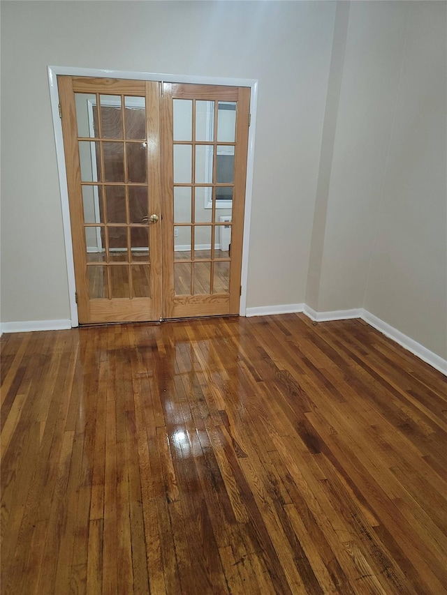 spare room with wood-type flooring and french doors