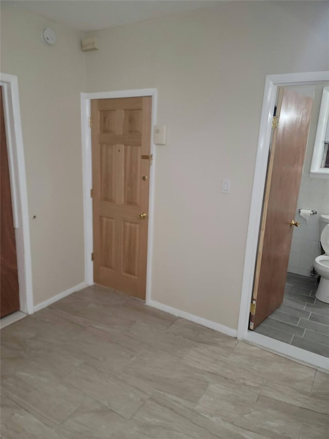 unfurnished bedroom with ensuite bath