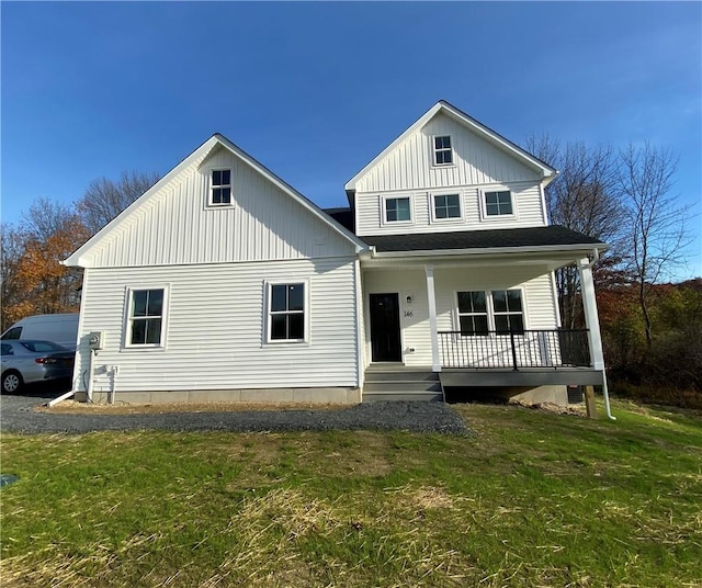 view of front of property with covered porch and a front lawn