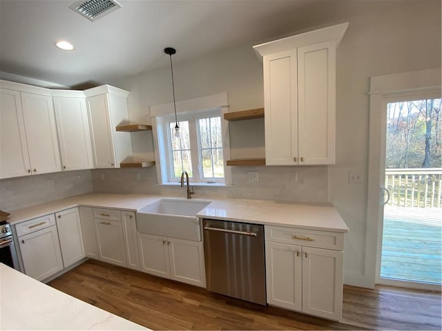 kitchen with light countertops, a sink, stainless steel dishwasher, and open shelves