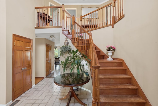 stairway featuring tile patterned flooring and crown molding