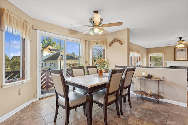 tiled dining space with ceiling fan