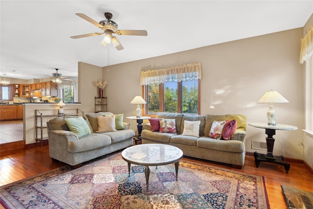living room with hardwood / wood-style flooring, ceiling fan, and a wealth of natural light