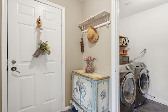 laundry area featuring independent washer and dryer and dark tile patterned flooring