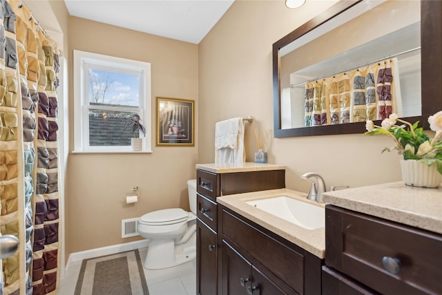 bathroom featuring tile patterned flooring, vanity, and toilet