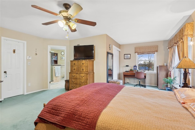 carpeted bedroom with ensuite bathroom and ceiling fan