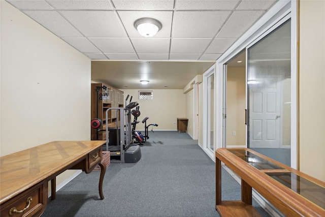 exercise room with a drop ceiling and carpet