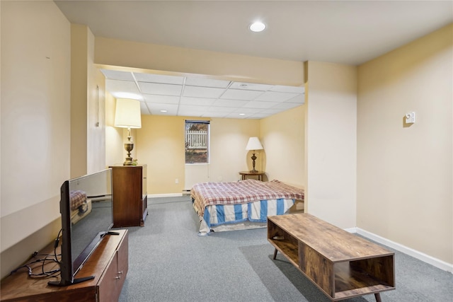 bedroom with a paneled ceiling, a baseboard radiator, and dark carpet