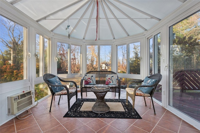 sunroom featuring a wall mounted air conditioner and vaulted ceiling with beams
