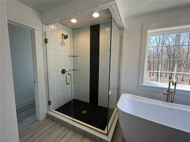 bathroom featuring independent shower and bath and sink