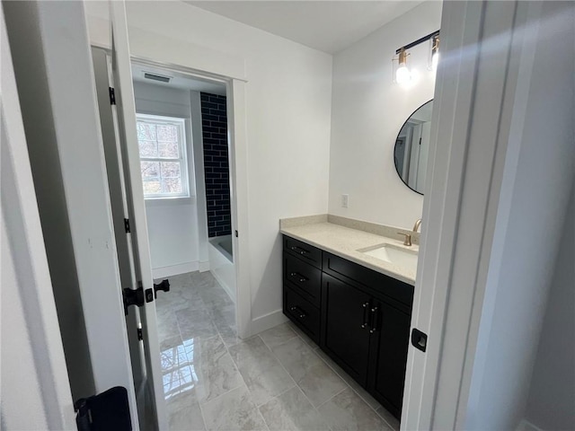 bathroom with vanity and tiled shower / bath combo