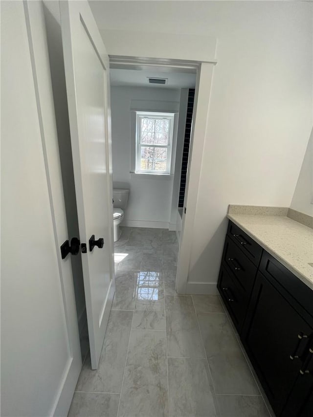 bathroom with vanity and toilet