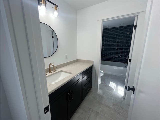 full bathroom with vanity, toilet, and tiled shower / bath