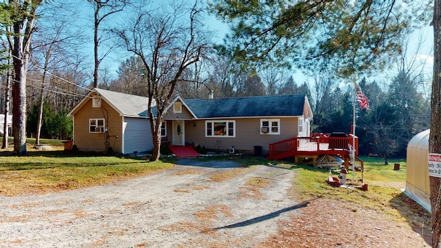 ranch-style home with a front yard and a deck