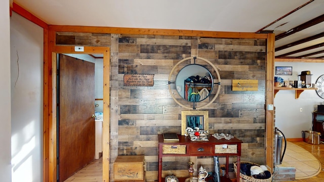 dining area with light wood-type flooring and wooden walls