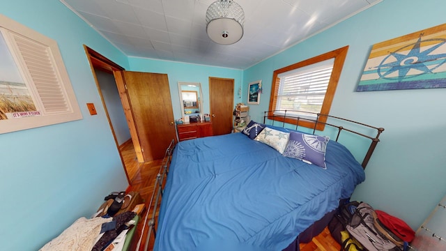 bedroom featuring parquet flooring