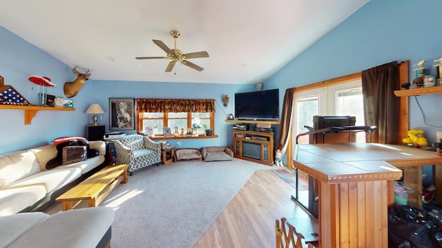 living room with light carpet, vaulted ceiling, and ceiling fan