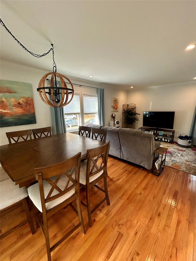 dining area featuring a notable chandelier and light hardwood / wood-style floors