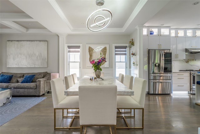 dining room featuring a raised ceiling, dark hardwood / wood-style flooring, ornamental molding, and a chandelier